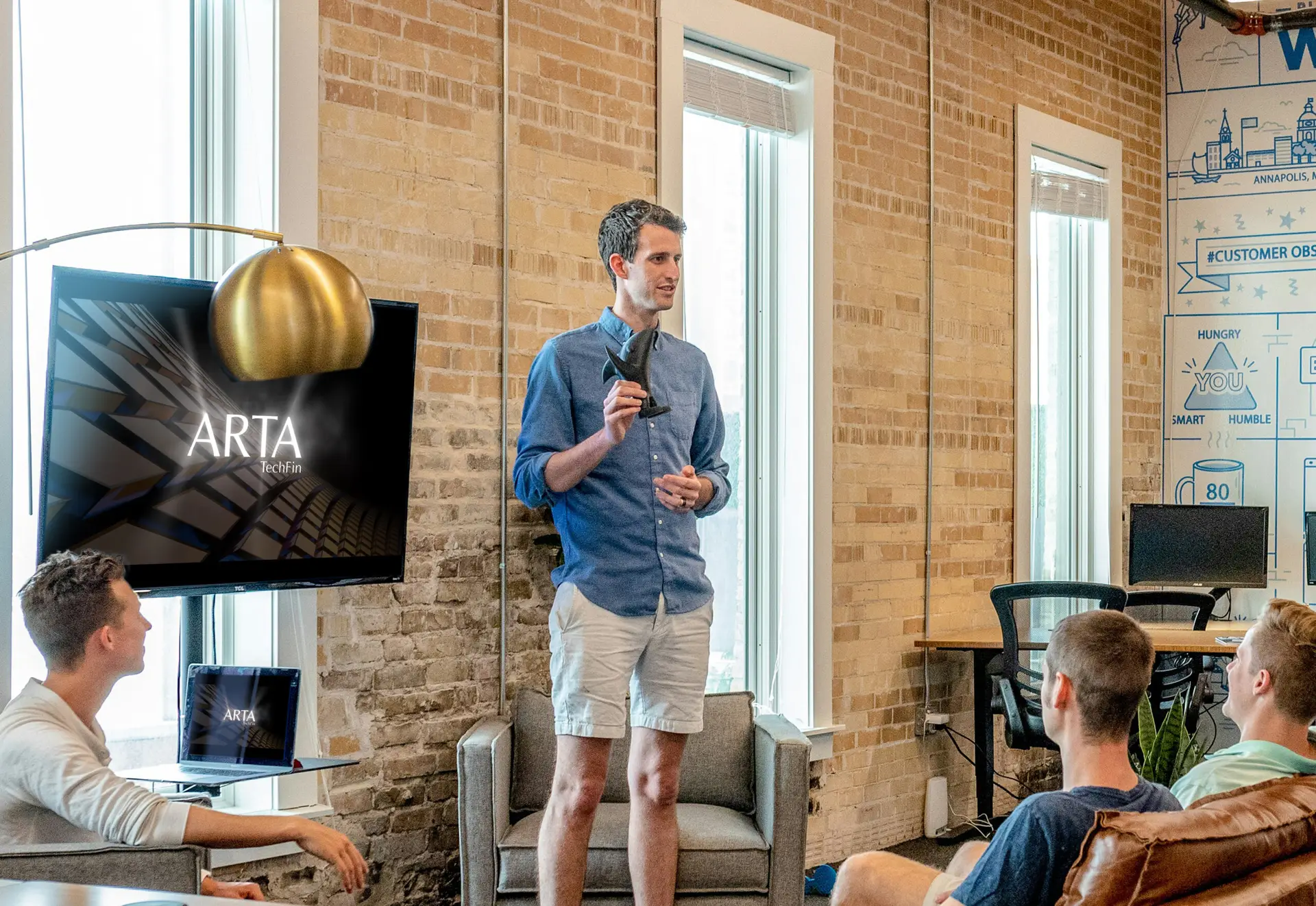 A presentation designer explaining a high-tech finance concept, showcasing effective PowerPoint design by a leading presentation design agency.