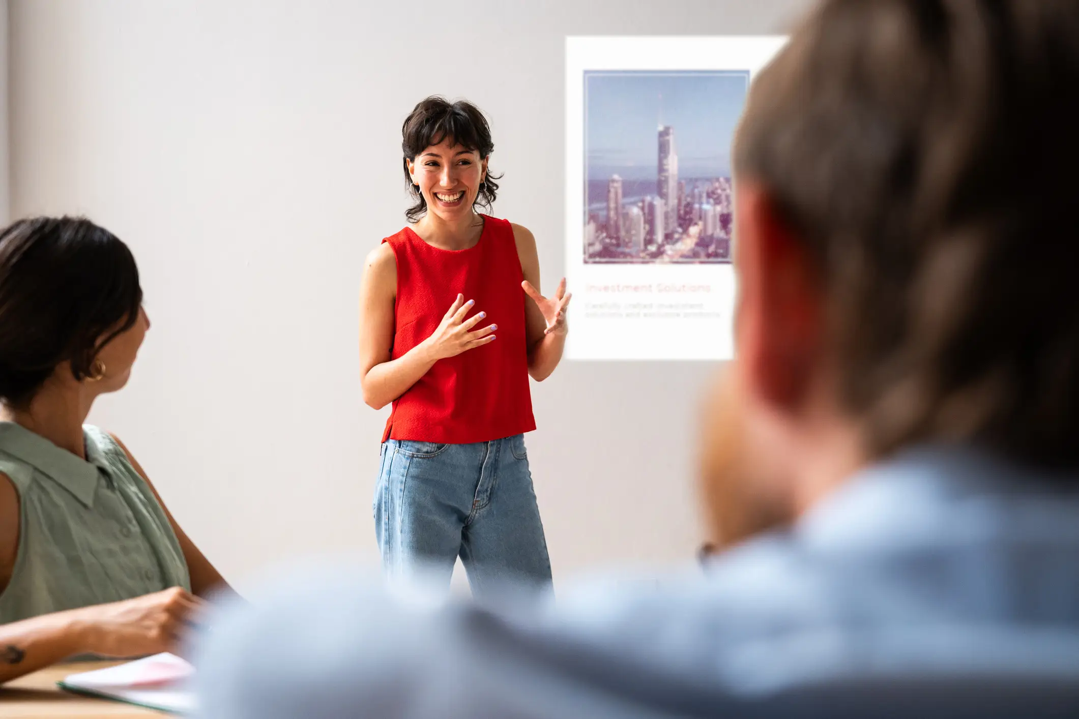 An engaging sales presentation depicted by a dynamic speaker using a visually appealing marketing deck to boost team enthusiasm and sales potential