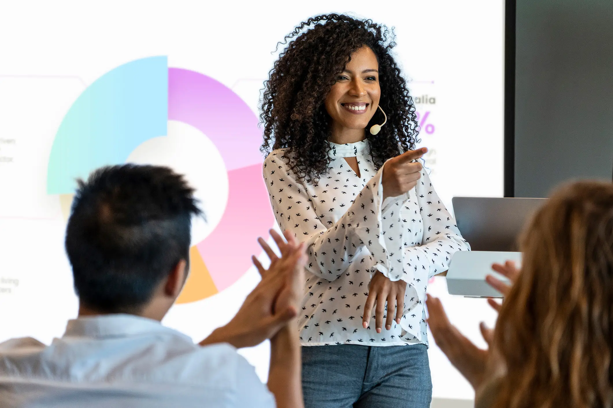 A dynamic professional delivers a resonant marketing presentation that effectively captivates the audience with storytelling through vibrant and engaging PowerPoint design